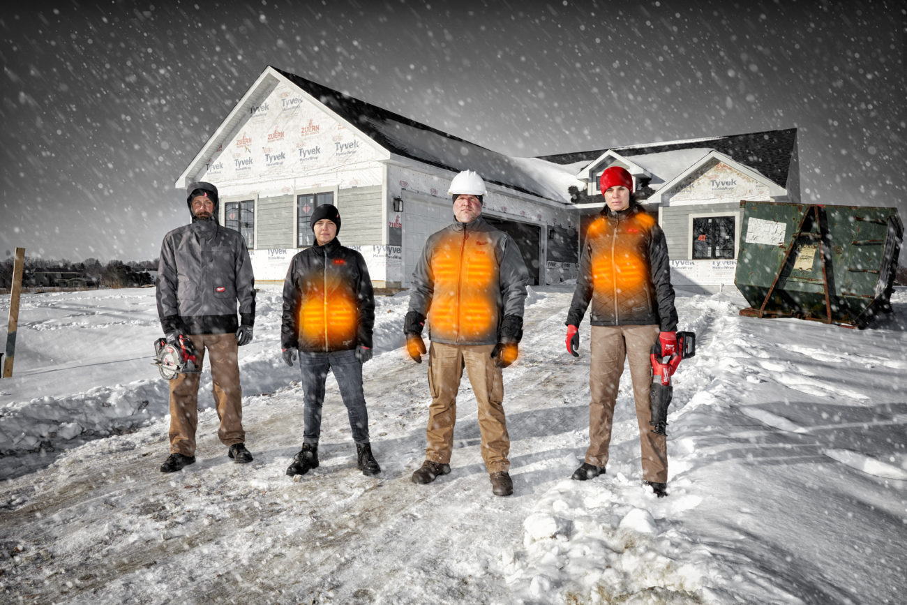 construction workers wearing heated coats in the snow