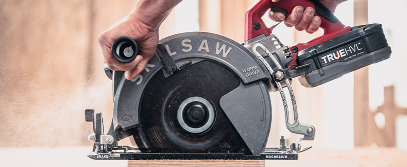 The 10-1/4 in. TrueHVL Cordless Worm Drive Saw (SPTH70M-01) cutting through wood.