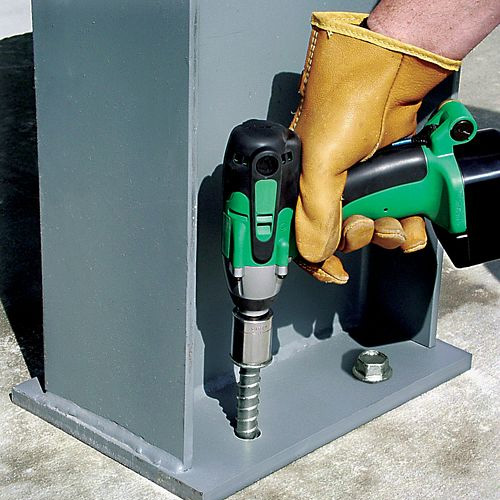 A Titen HD Screw Anchor is being installed into the base of a fixture to secure it to concrete.