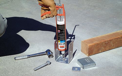 The AT-XP Adhesive is being applied to attach a fixture. 