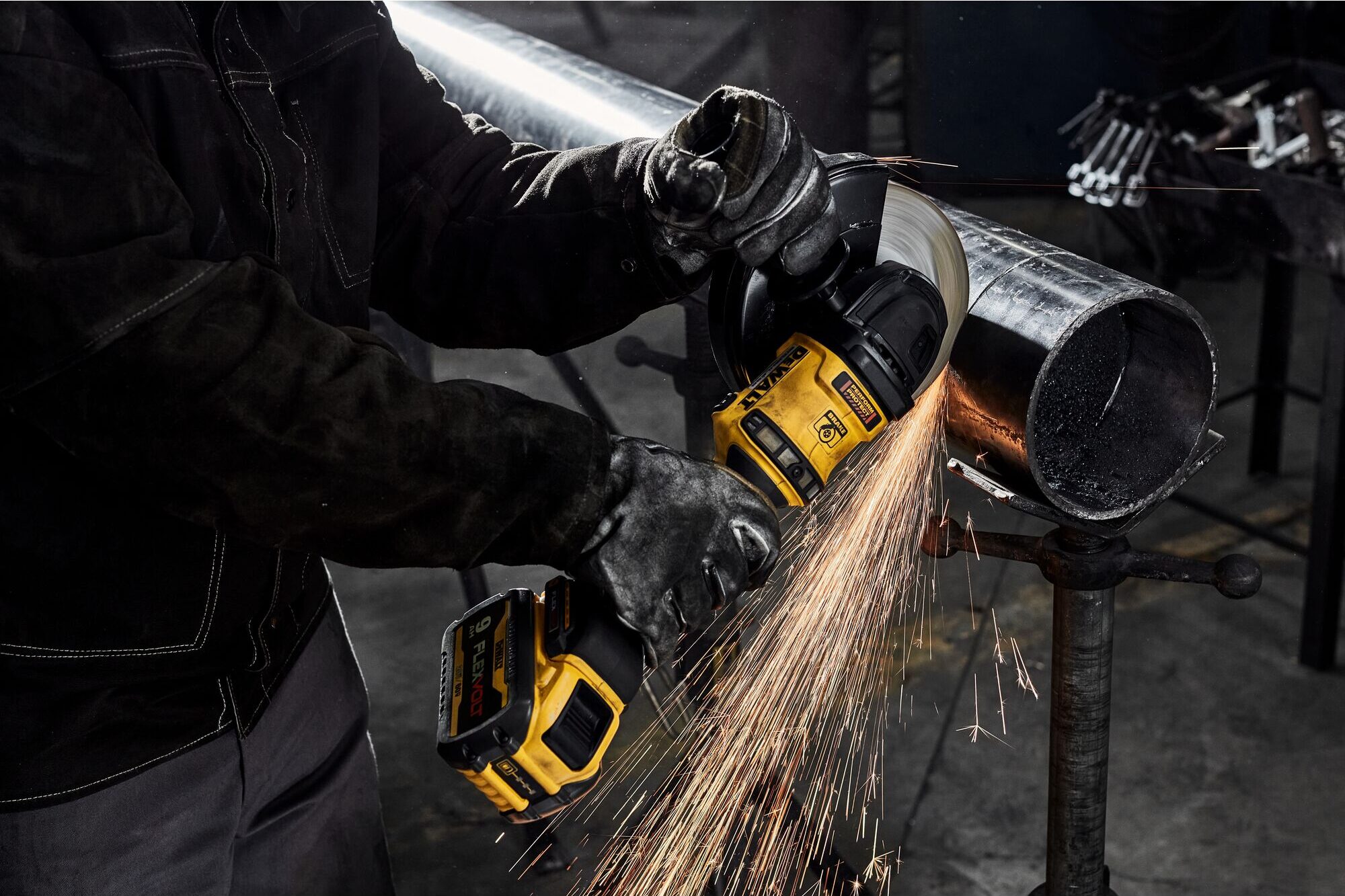 The 60V MAX Brushless Cordless 7-In. FLEXVOLT Grinder with Kickback Brake-- the newest and most powerful cordless angle grinder from DeWalt-- cuts through a metal pipe. 