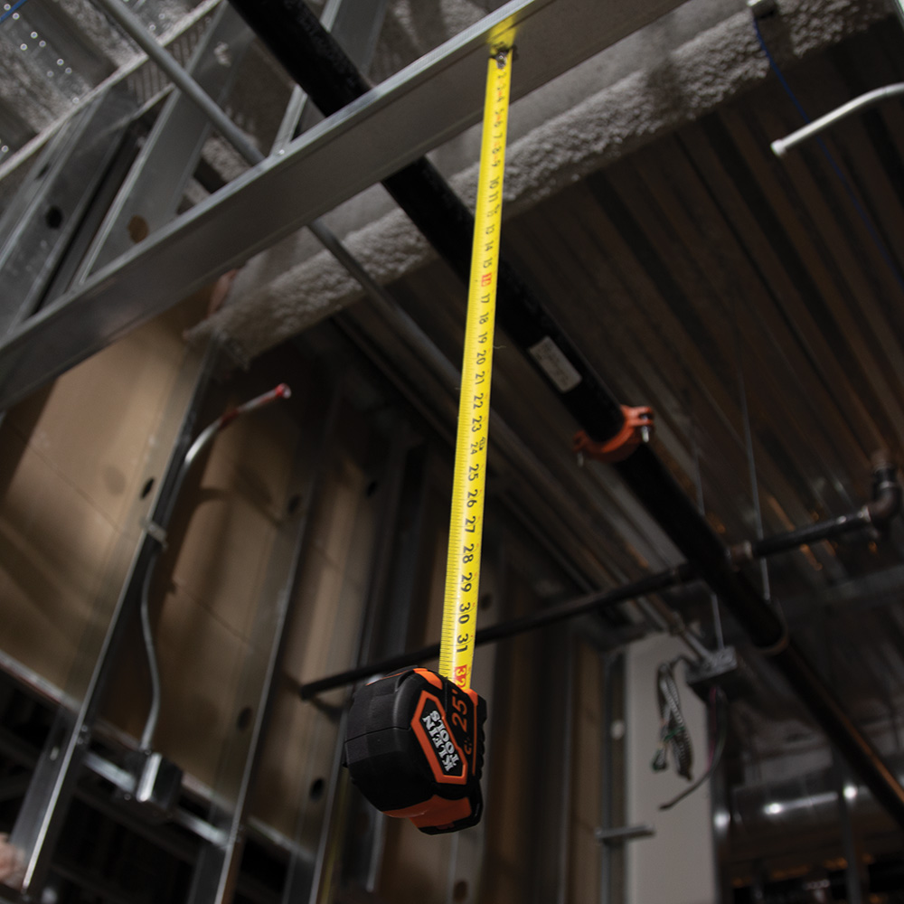 Klein Tape Measure demonstrating its magnet on the jobsite